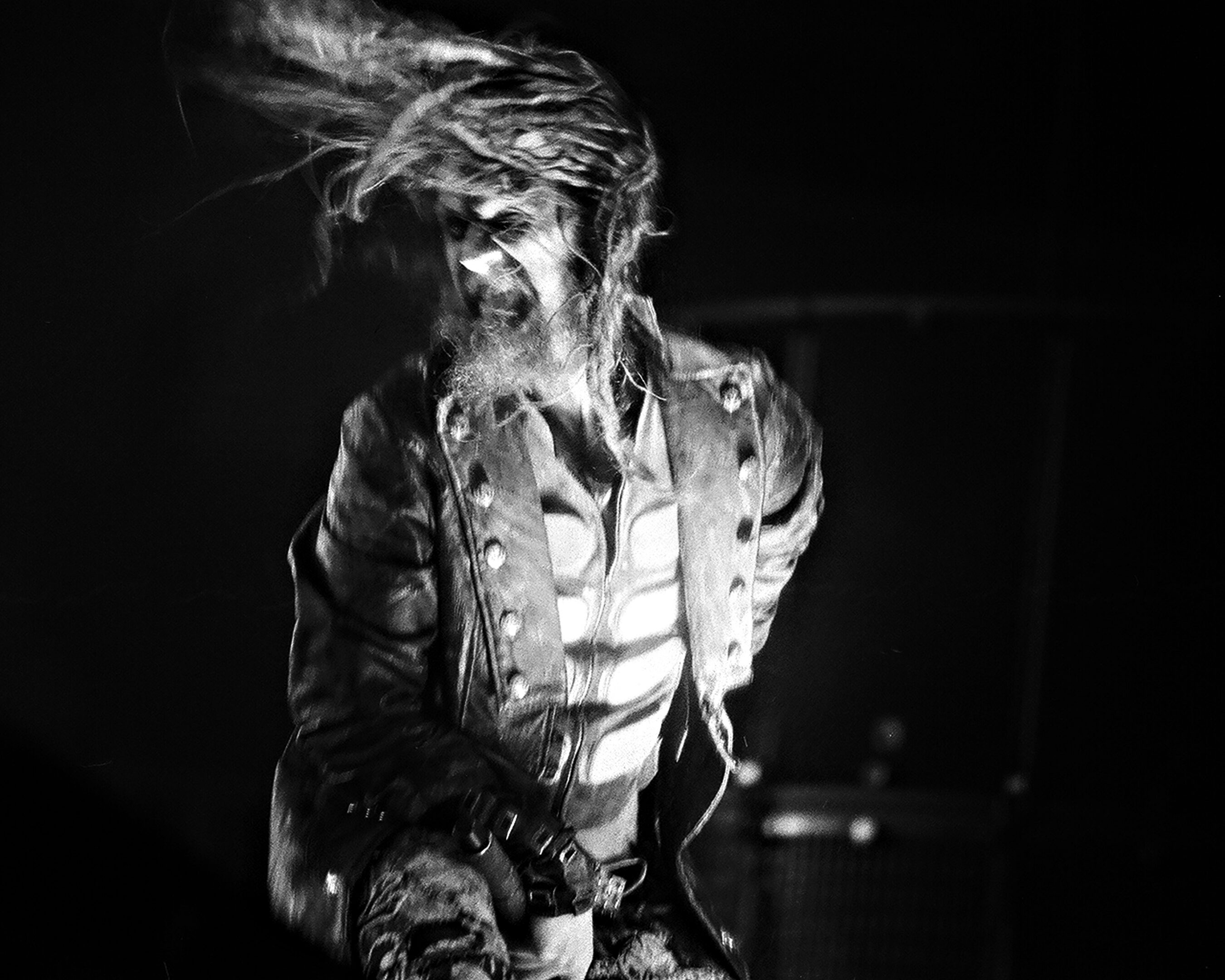 Performer on stage with dynamic hair movement.