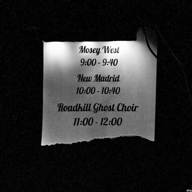 Concert schedule displayed on a lit sign.