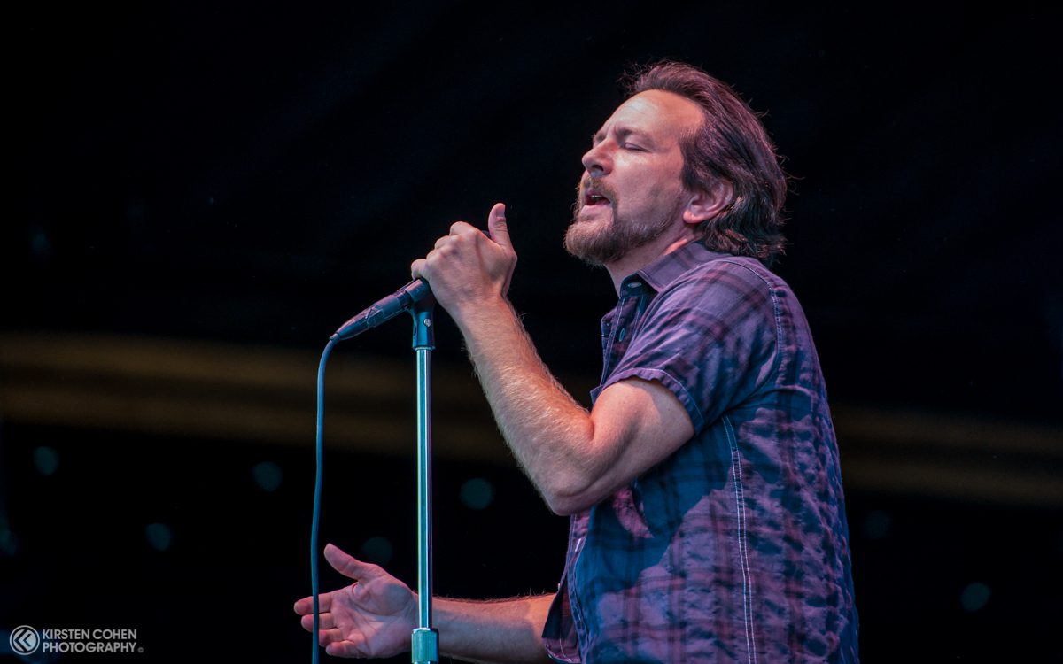 Singer performing passionately on stage with microphone.