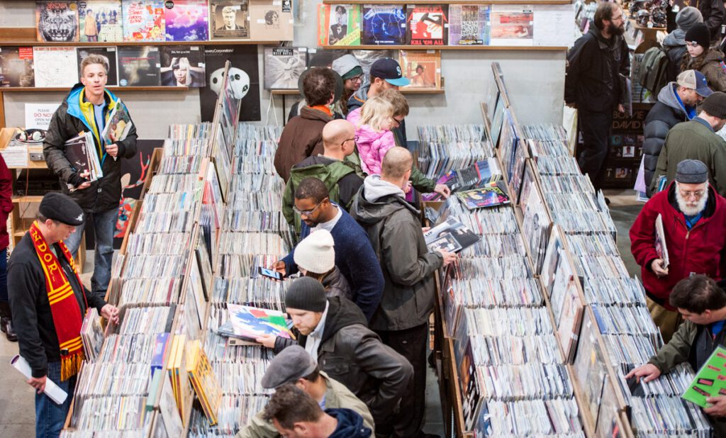 People browsing records in a busy store.