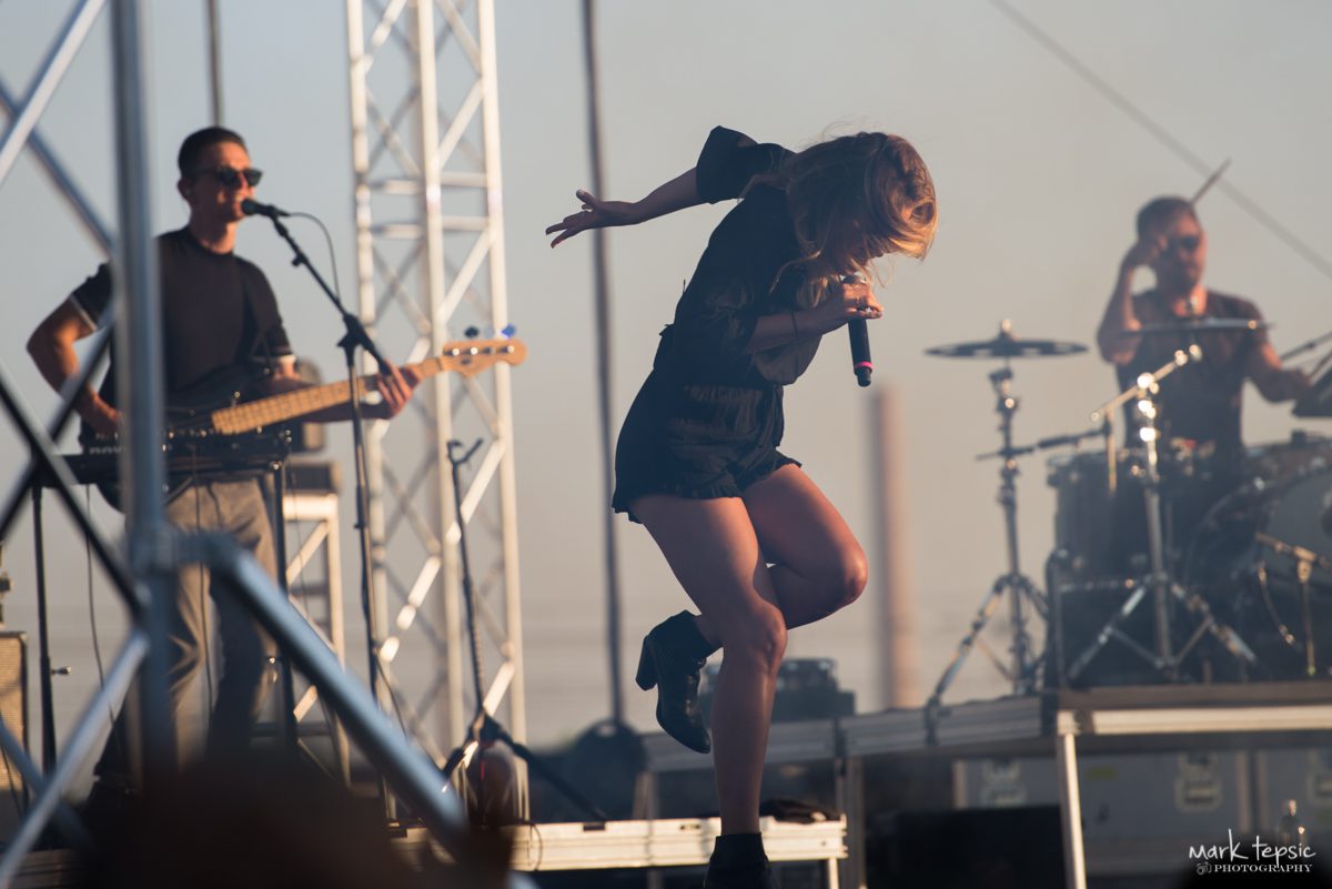 Band performing energetically on outdoor stage.