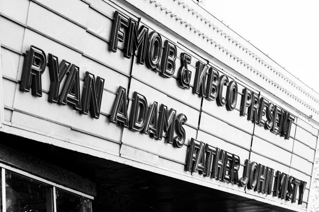 Theater marquee with concert announcement sign.