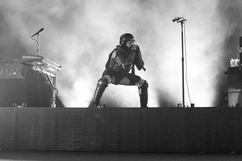 Performer in costume on stage with microphone.