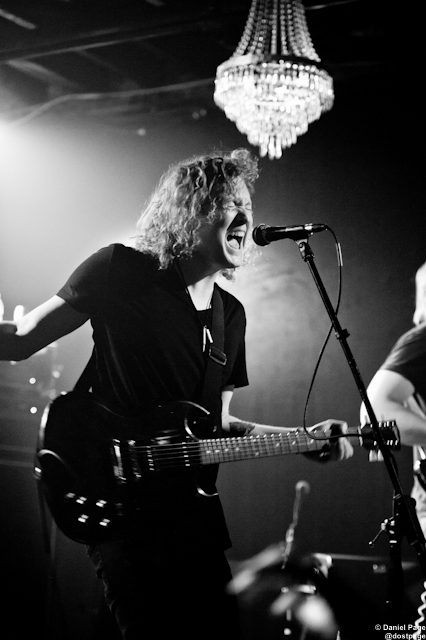 Musician performing passionately under a chandelier.