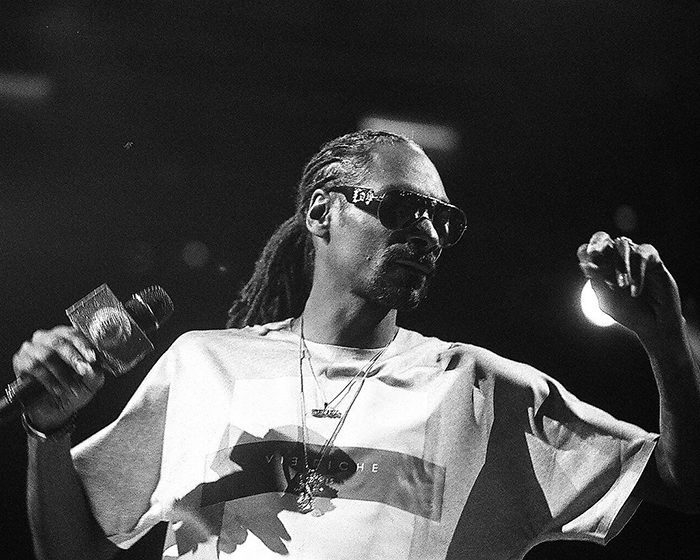 Artist performing on stage with microphone.