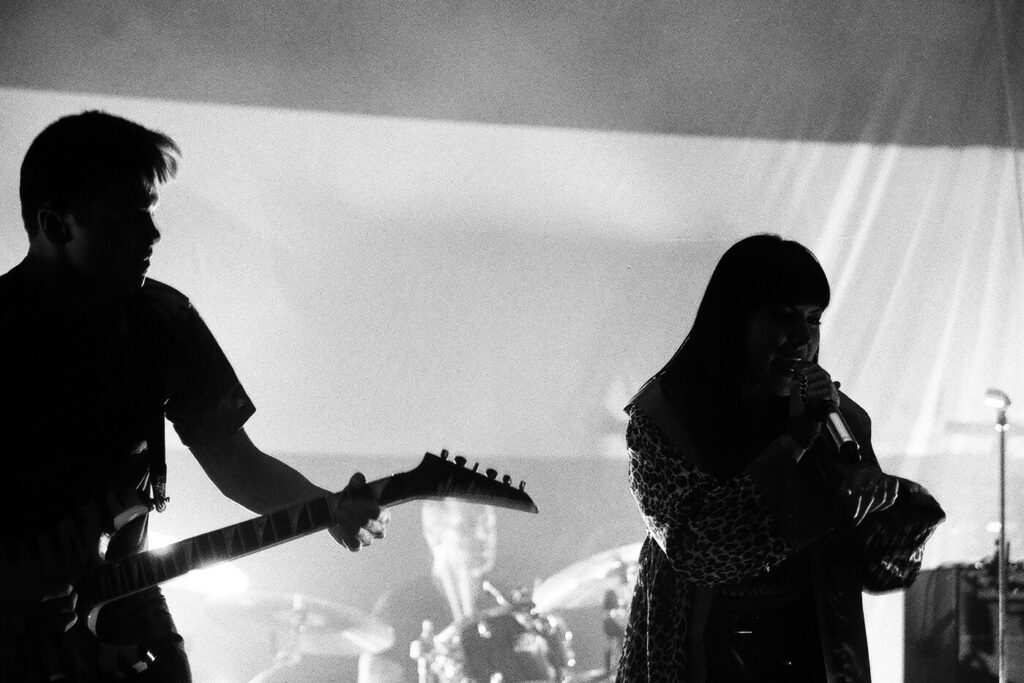 Band performing on stage in black and white.