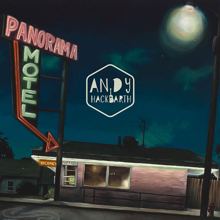 Nighttime motel scene with neon signs.