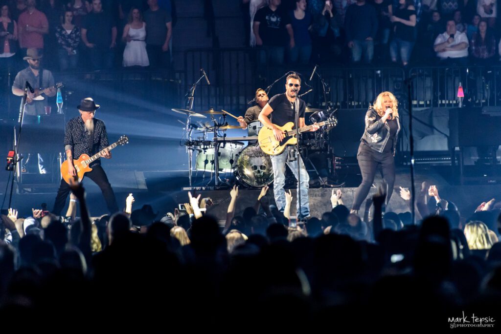 Band performing live on stage at concert.
