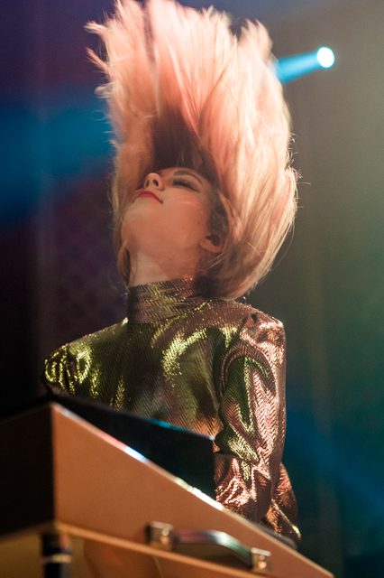 Musician performing energetically on stage.