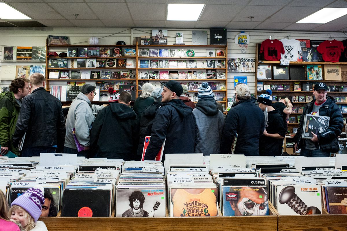 People browsing records in a music store.