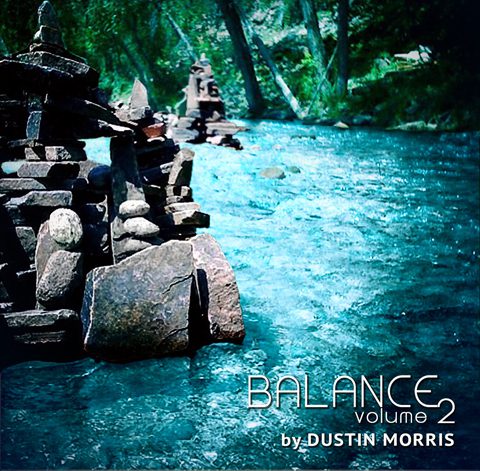 Stacked stones by a flowing river.