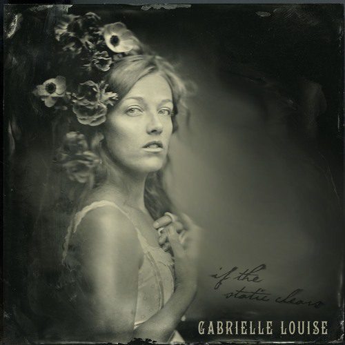 Woman with flowers in sepia-toned portrait.