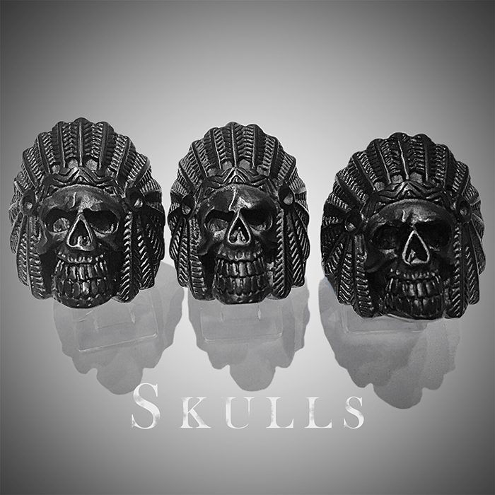 Three skull rings with intricate headdress designs.