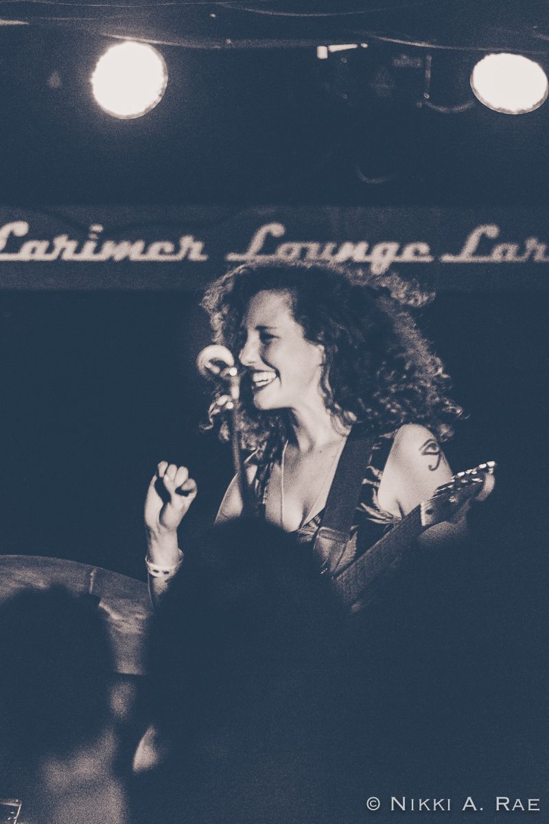 Smiling musician performing at a concert.