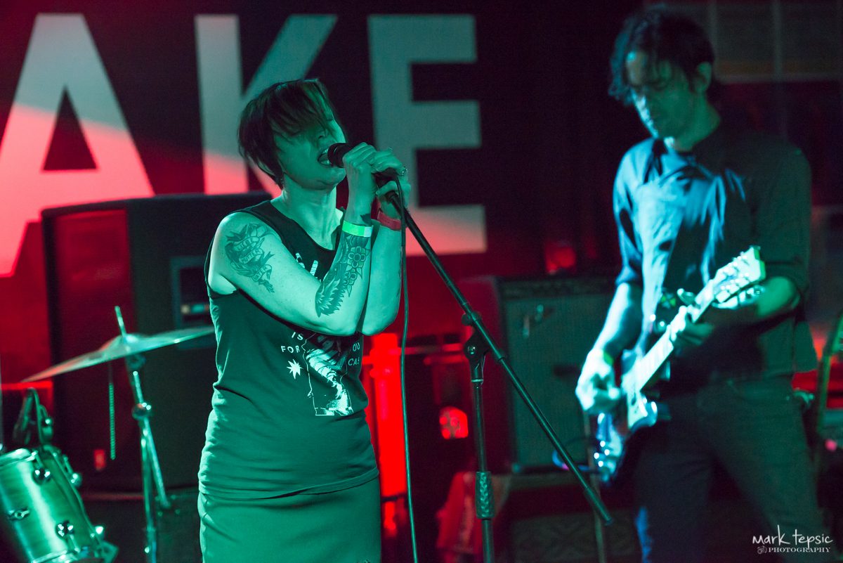 Singer and guitarist performing on stage.