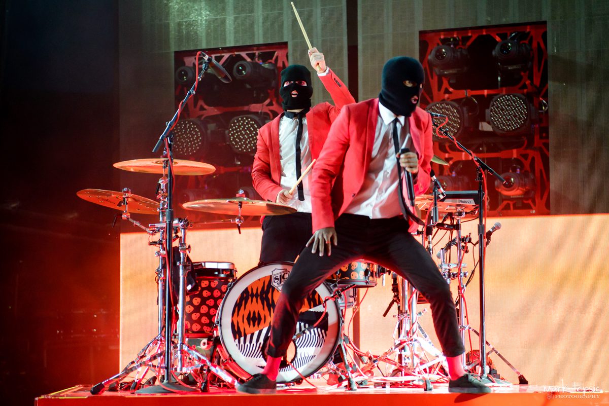 Musicians in red suits performing on stage.