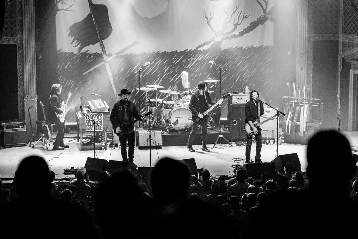 Black and white rock band concert performance.