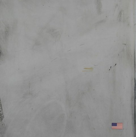 Gray textured surface with small American flag.