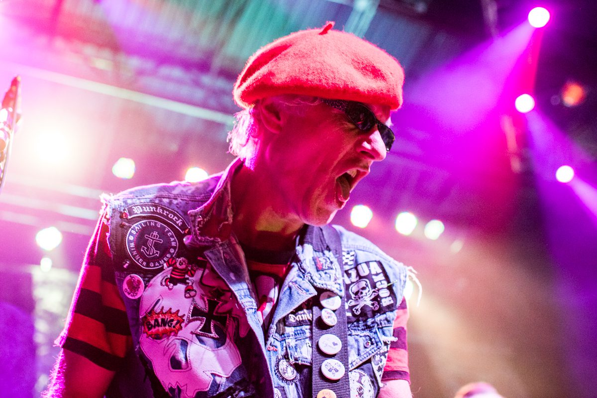 Musician performing energetically on stage.