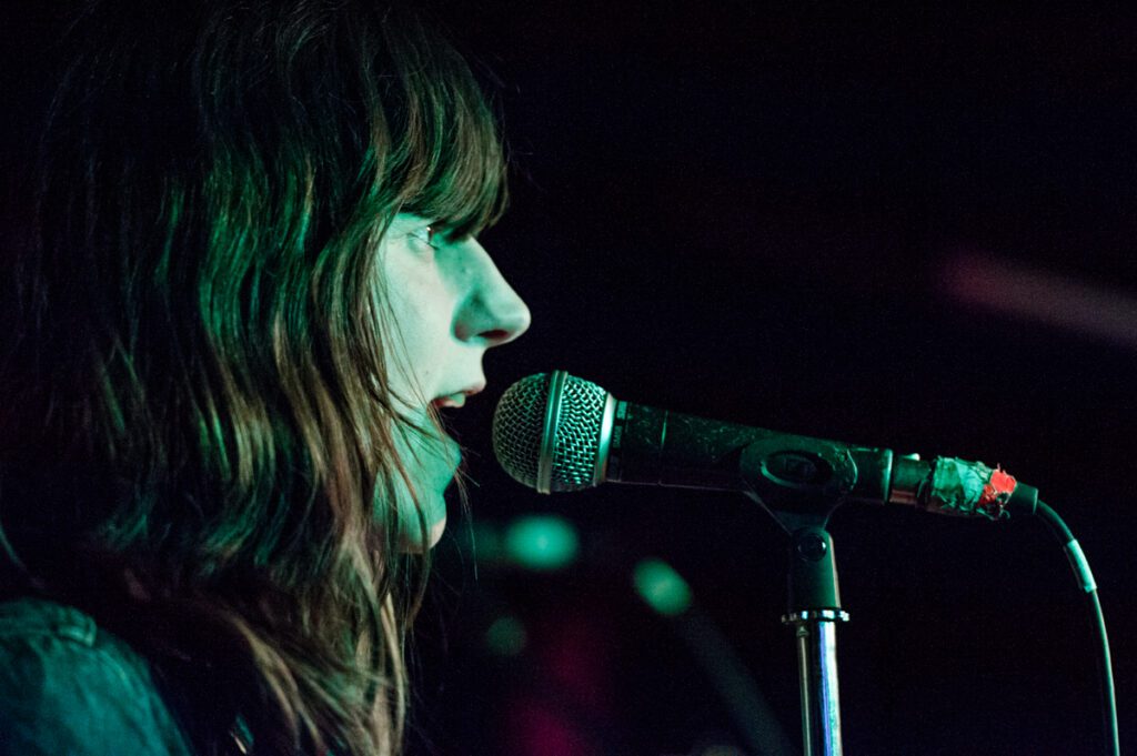 Singer performing on stage with microphone.