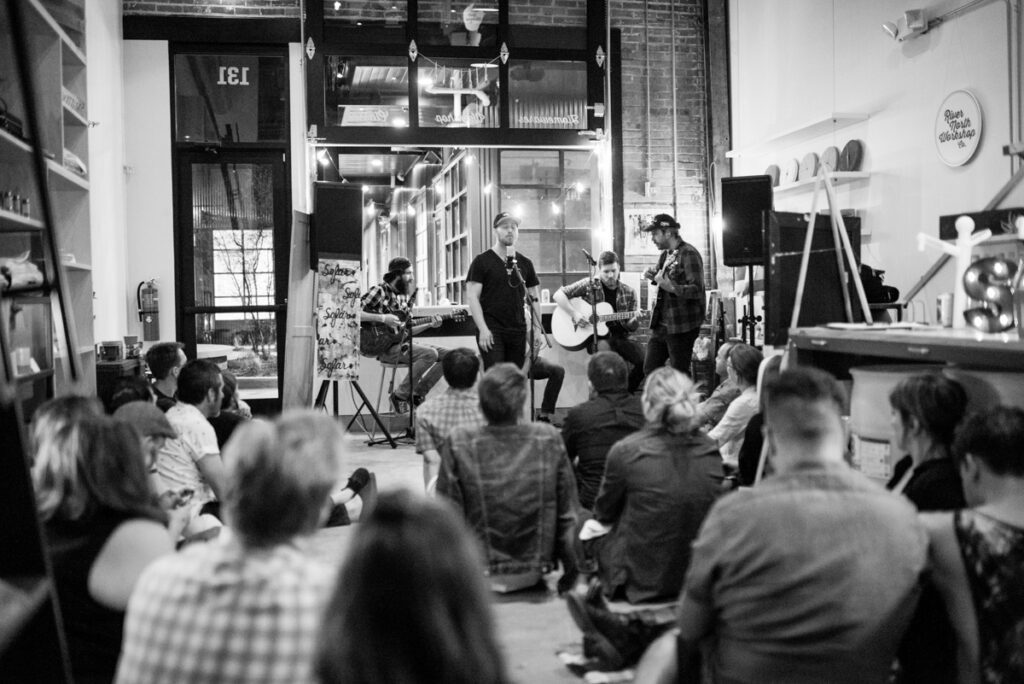 People enjoying live acoustic music performance indoors.