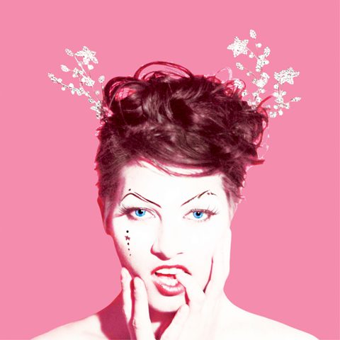 Woman with artistic makeup on pink background.