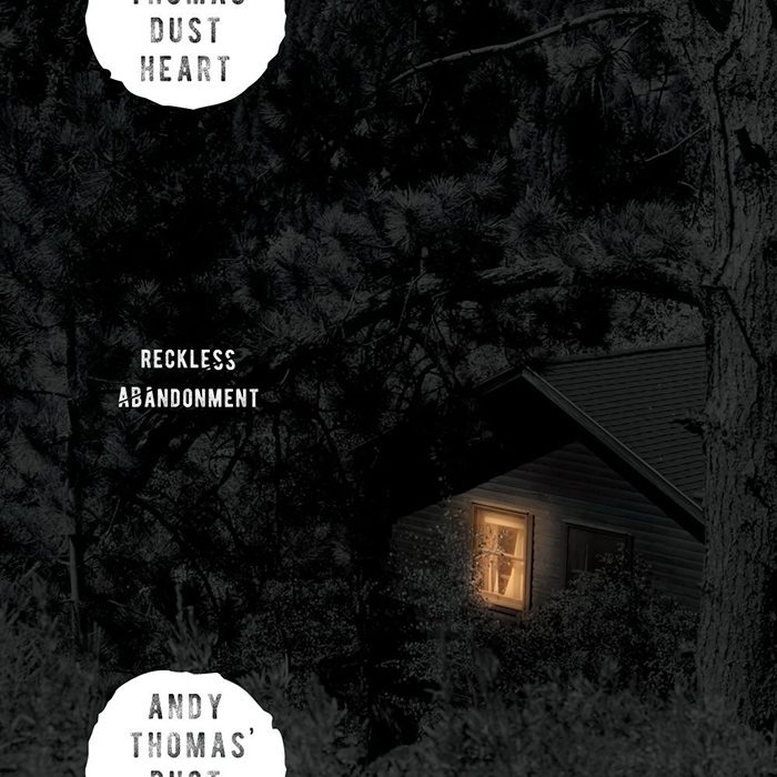 Cabin with light in dark forest.
