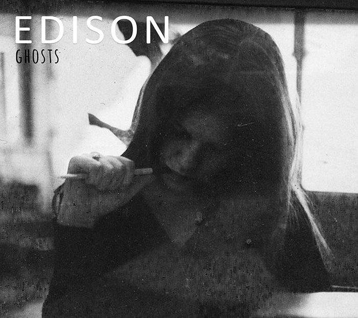 Woman writing in dimly lit room.