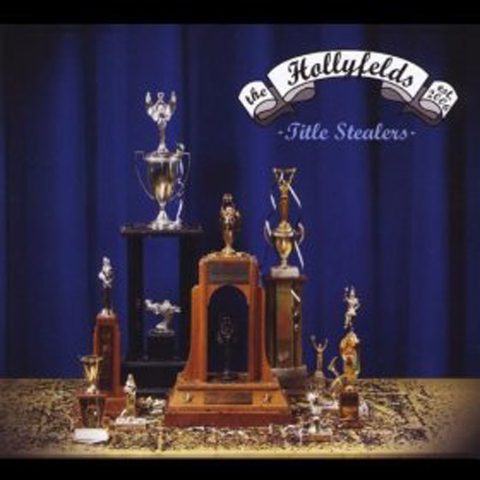 Trophies displayed on a table, blue backdrop.