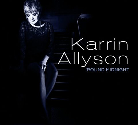 Singer sitting on stairs, album cover.