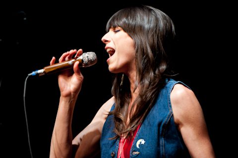 Singer performing passionately with a microphone.