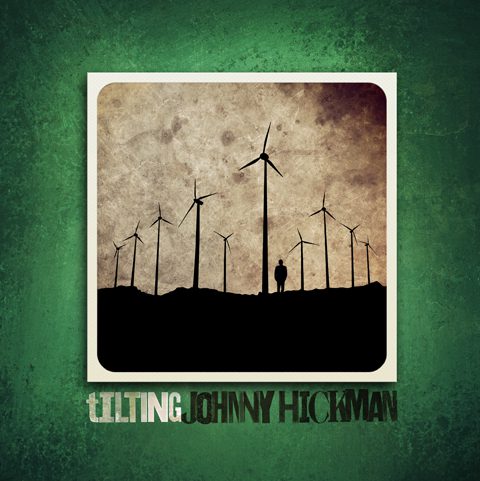 Silhouette of wind turbines and person.