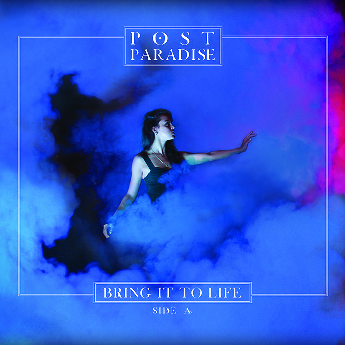 Woman in smoky blue and purple light.