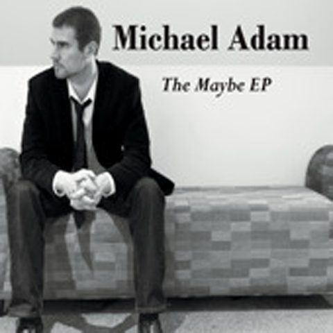 Man sitting on a sofa, album cover.