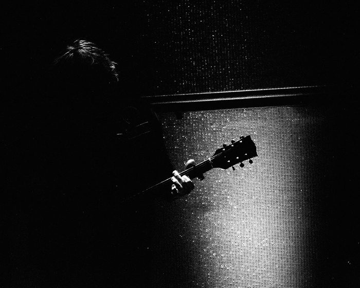 Silhouette of guitarist with electric guitar.