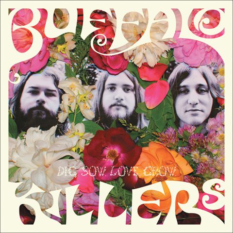 Album cover with flowers and three faces.