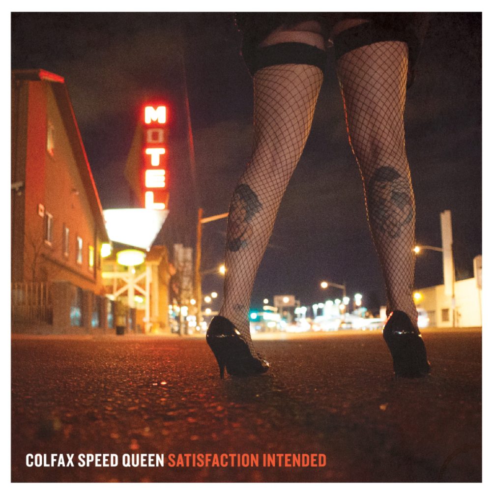 Legs in fishnets near a motel sign.