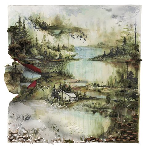 Scenic landscape with lakes and forested hills.