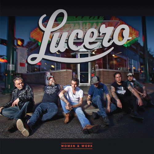 Band sitting outside diner, "Lucero" sign above.