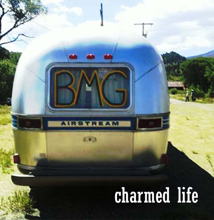 Airstream trailer with "charmed life" text.