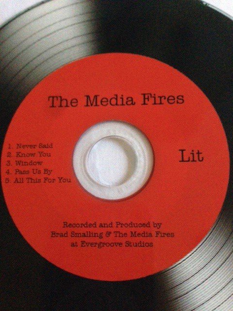 Red music CD titled "The Media Fires.