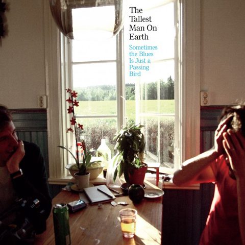 Two people sitting in sunlit room.