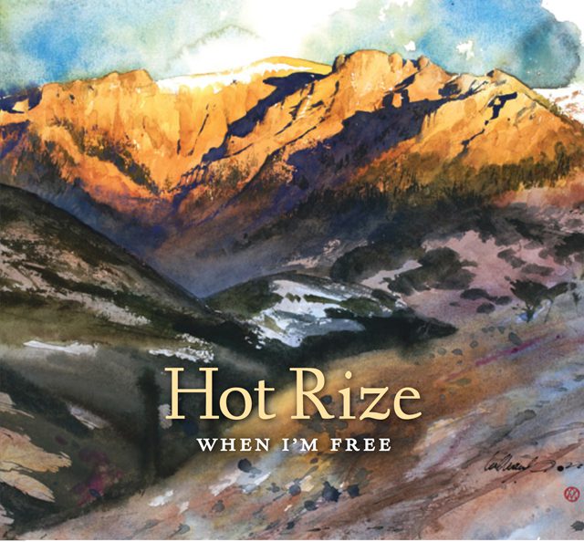Mountain landscape with "Hot Rize" album cover.