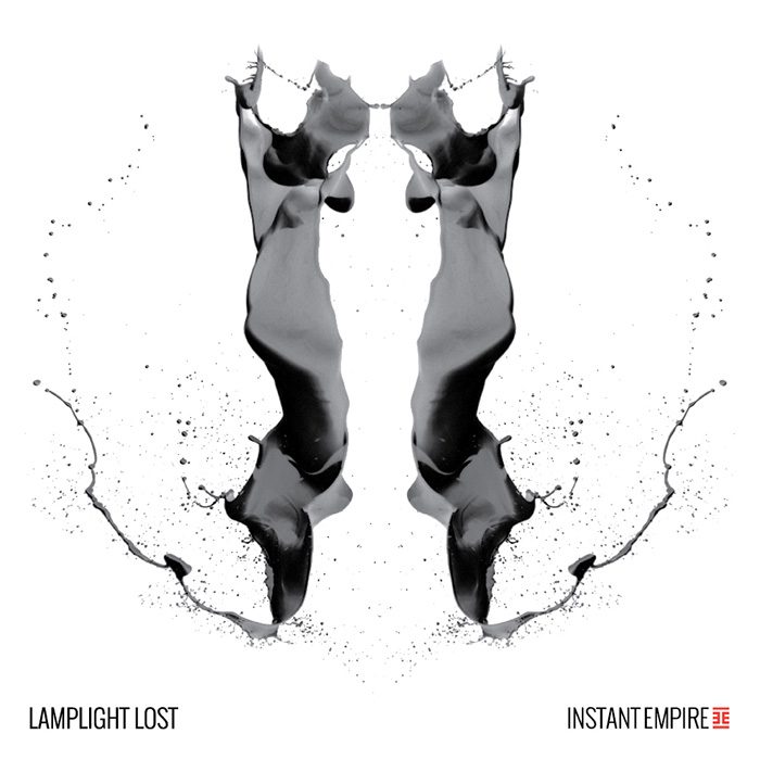 Black inkblot on white background, symmetrical design.
