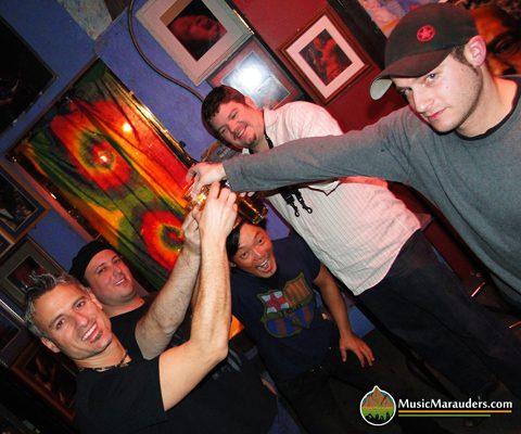 Group of friends toasting with drinks.