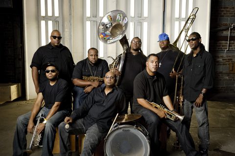 Band members posing with musical instruments.
