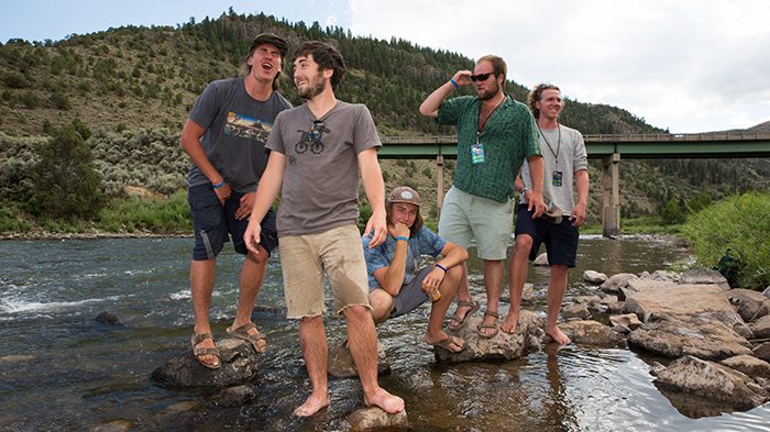 Group of friends posing by a river.