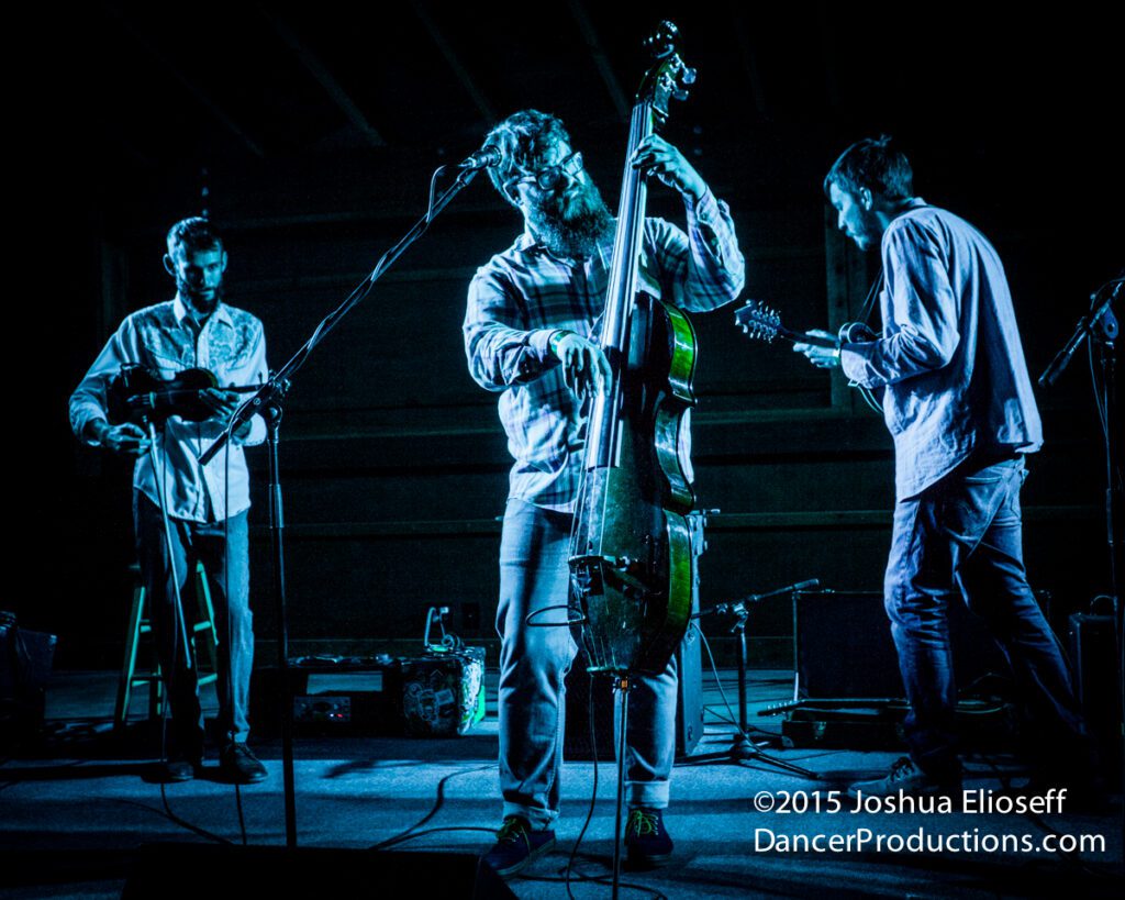 Musicians performing on stage with instruments.