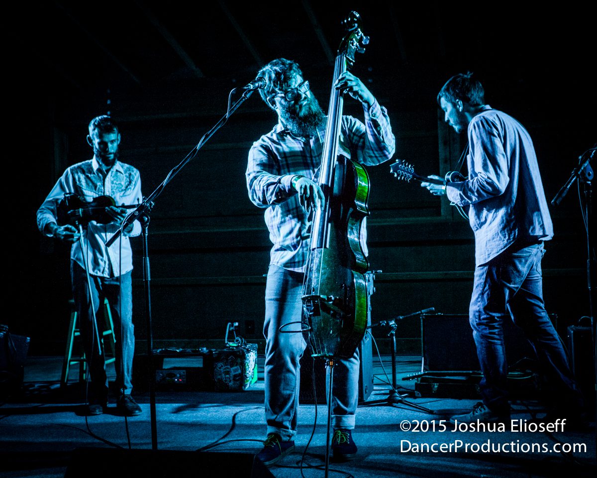 Musicians performing on stage with instruments.