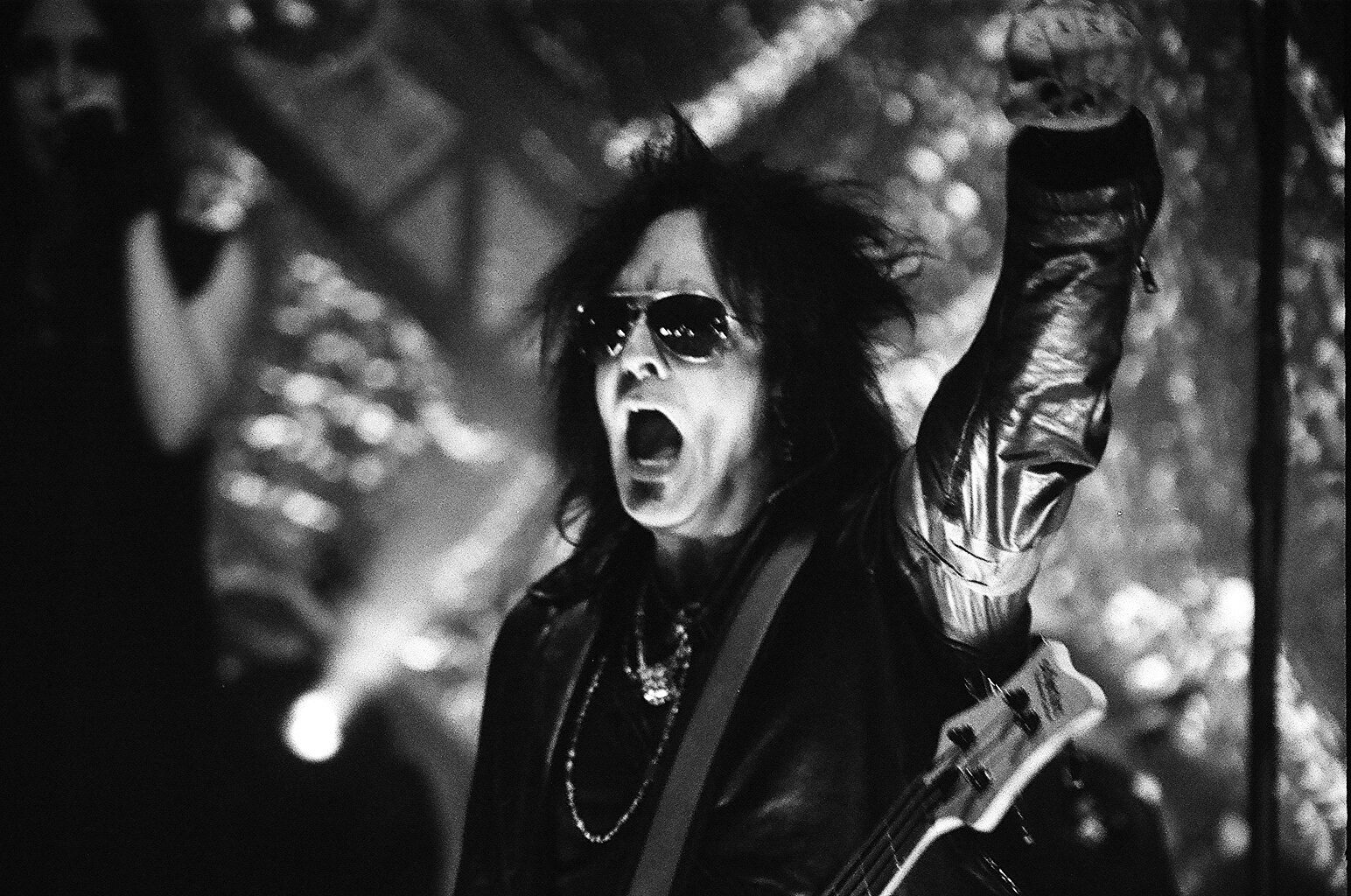 Rock musician performing energetically on stage.